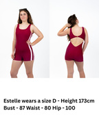 Front and back view of girl wearing The OG boy leg one-piece swimsuit in cherry maroon with pink side stripe detail, round scoop neckline, gold clasp back closure, and full coverage fit.