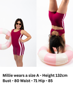 Front and back view of girl wearing The OG boy leg one-piece swimsuit in cherry maroon with pink side stripe detail, round scoop neckline, gold clasp back closure, and full coverage fit.
